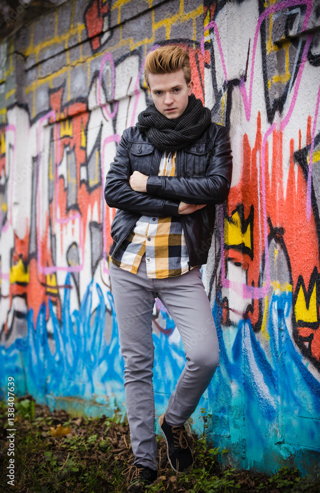 Fashion male portrait on graffiti wall Fashion male portrait on graffiti wall