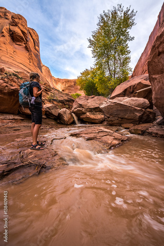 Backpacker crossing small stream Coyote Gulch © Krzysztof Wiktor
