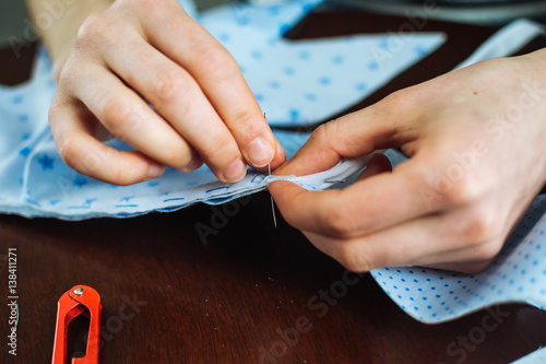 Young woman handsewing, close up view