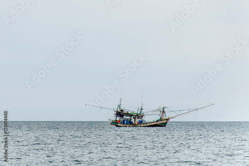 Fishing boat big fishermen with fish net on the blue ocean catch fish