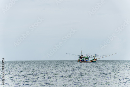 Fishing boat big fishermen with fish net on the blue ocean catch fish