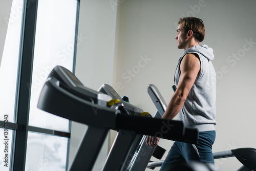 Get the best body you can this with this gym. Fit man exercising on the treadmill at his local gym