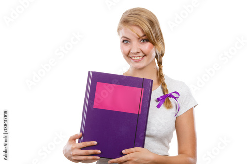 Young teenage student with braid holding books