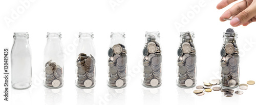 Saving money concept of collecting coins in glass bottle Isolated on white background. copy space.