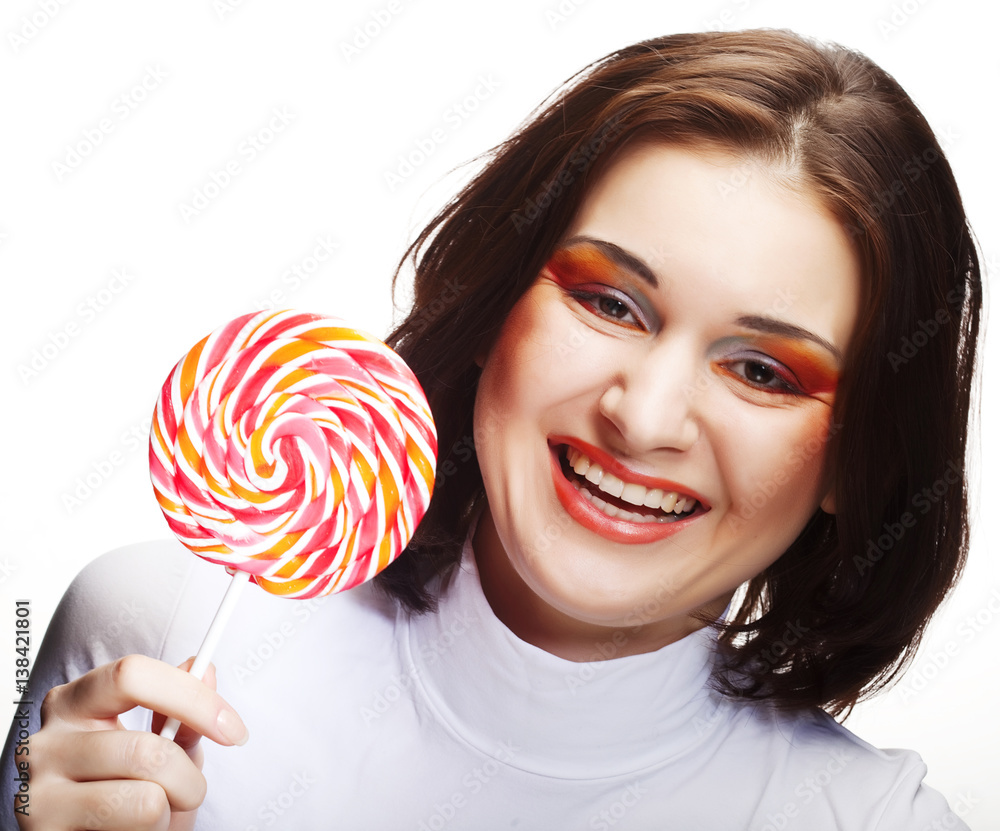 Pretty young woman holding lolly pop. 