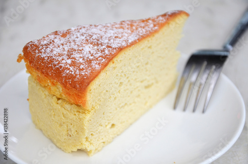 Yellow cheese cake on table