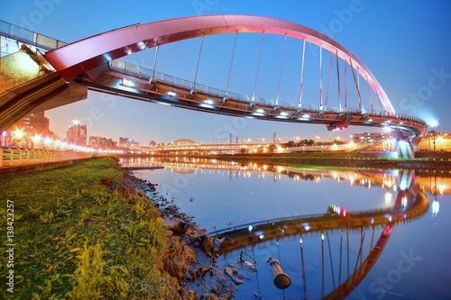The famous Rainbow Bridge over Keelung River with reflections on smooth water at dusk in Taipei, Taiwan, Asia ~ A romantic landmark of Taipei, the capital city of Taiwan, under beautiful evening sky