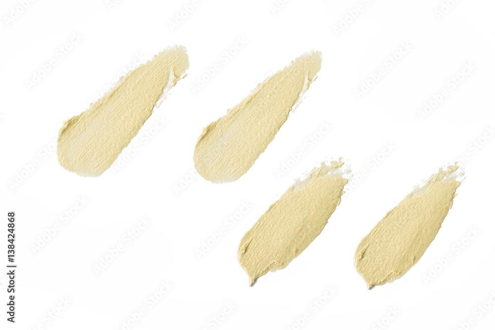 Smudged pearl color cosmetic concealer on background Smudged pearl color cosmetic concealer on background