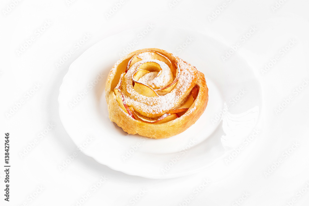 Sweet rose style twisted cake of pastry puff on plate isolated at white background. Sweet rose style twisted cake of pastry puff on plate isolated at white background.