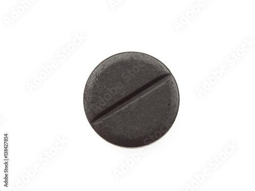Active black charcoal pills isolated on white background