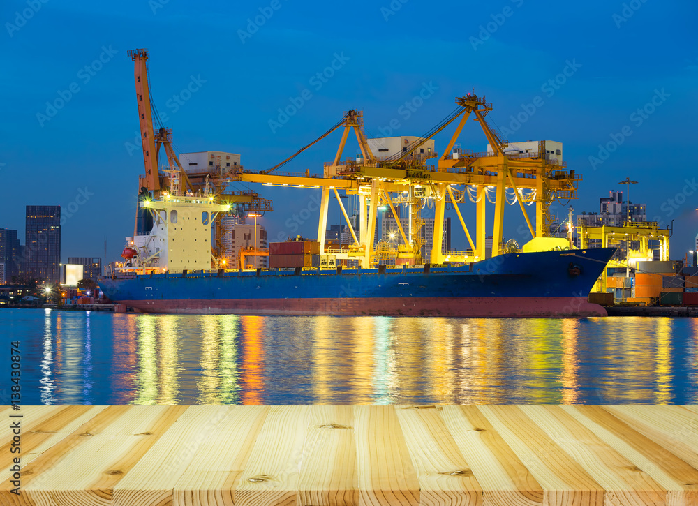 Obraz premium Gantry crane loading and unloading cargo container from cargo ship at port to show global international logistics and transportation by cargo ship and cargo container, Logistic import export concept.