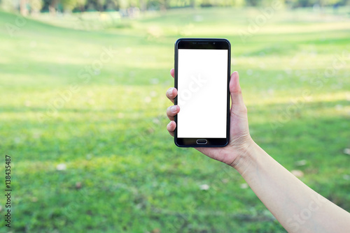 Hand holding smartphone on glass background