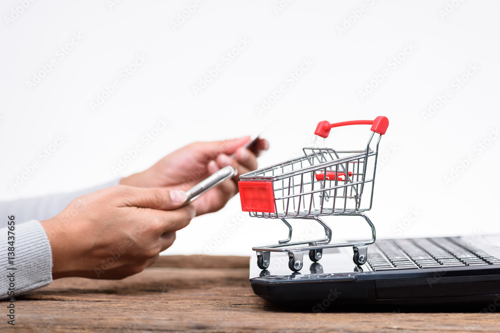 Hands holding credit card and using laptop. Online shopping Hands holding credit card and using laptop. Online shopping