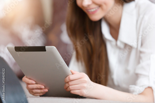Young attractive girl sitting with a tablet in the hands