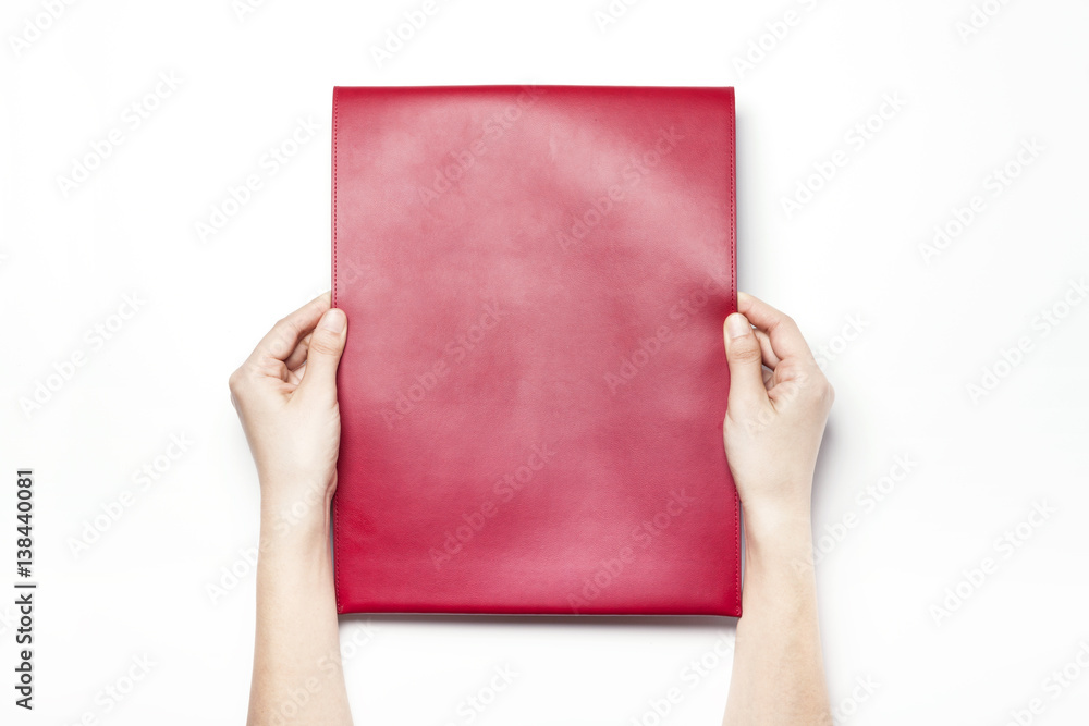 woman hand hold a red leather envelope isolated white. woman hand hold a red leather envelope isolated white.