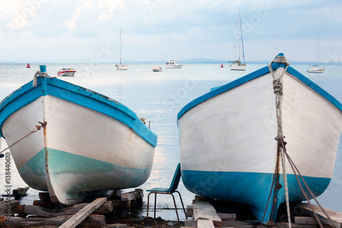 Vászonkép Boats moored by the shore