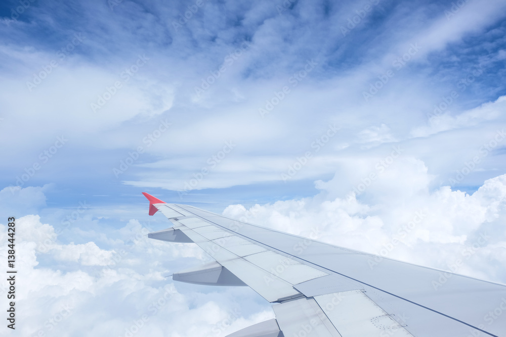Fototapeta premium Airplane wing on beautiful dramatic sky with cloud