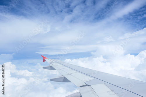 Airplane wing on beautiful dramatic sky with cloud