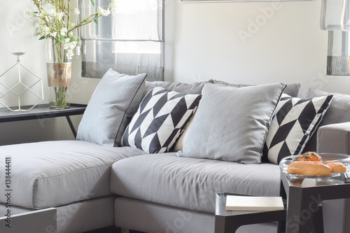 Black and white parallelogram pattern pillows on gray comfy sofa