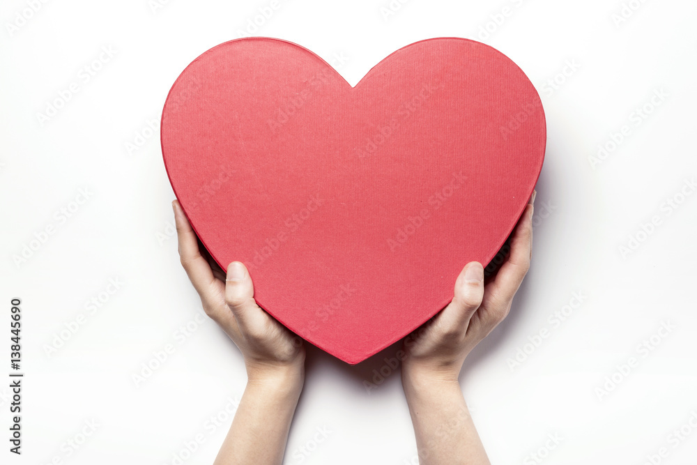 Woman hand hold a red heart gift box isolated white. Woman hand hold a red heart gift box isolated white.