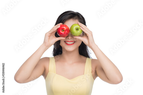 Pretty young asian woman holding fresh apple isolated on white background. © makistock
