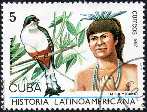 UKRAINE - CIRCA 2017: A stamp printed in Cuba, shows Image of a chieftain Hatuey Cuba and bird Cuban Trogon Priotelus temnurus, the series Latin American history, circa 1987 photo