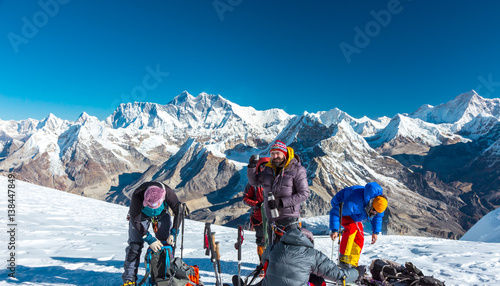 Group of Mountain Climbers preparing for ascent on high Peak