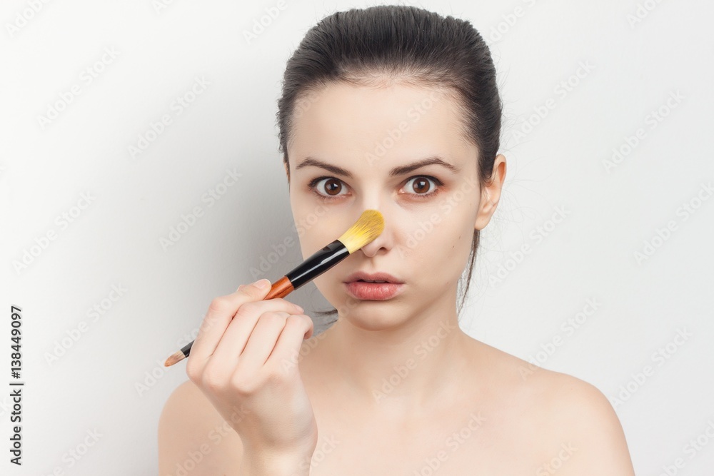 make-up brush and a woman with fair complexion make-up brush and a woman with fair complexion