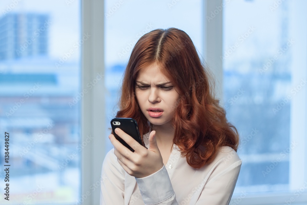 business woman looking into the phone business woman looking into the phone