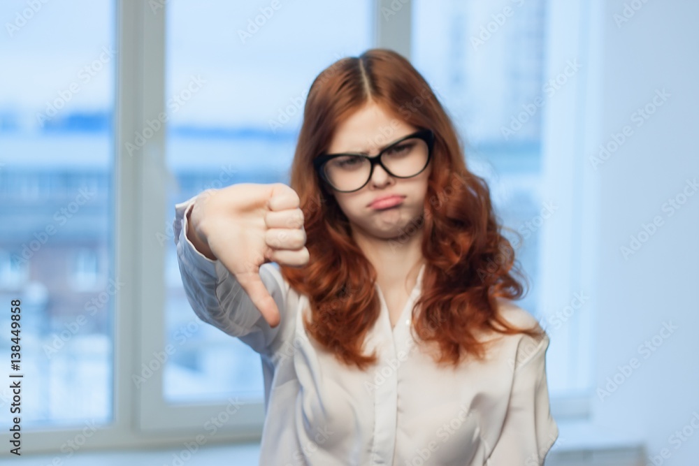 Fototapeta premium woman shows thumb thumb upside down