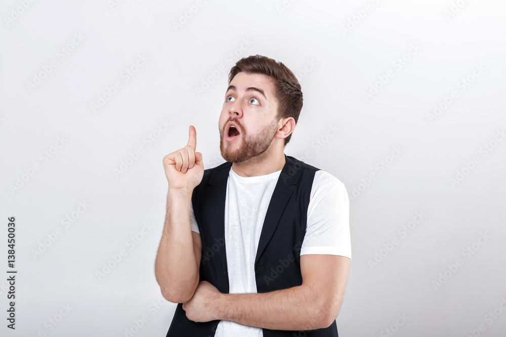 portrait of young attractive surprised man in white shirt on gra portrait of young attractive surprised man in white shirt on gra