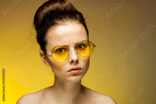watchful woman in yellow glasses © SHOTPRIME STUDIO