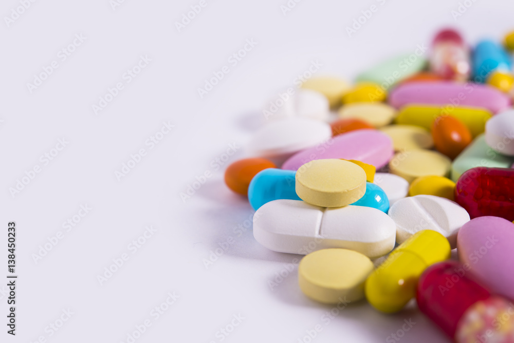 Multicolored pills and tablets on white background Multicolored pills and tablets on white background