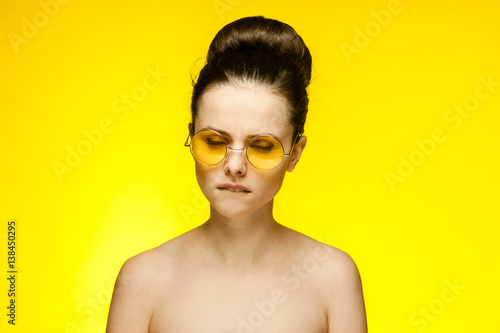 yellow background and beautiful brunette with glasses