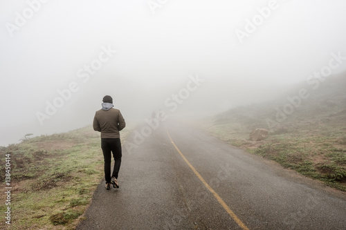 Lone man walking through the white fog © haveseen