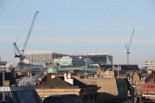 A view of the football stadium (St. James Park) looming large over the surrounding buildings in the centre of the city of Newcastle-Upon-Tyne, England