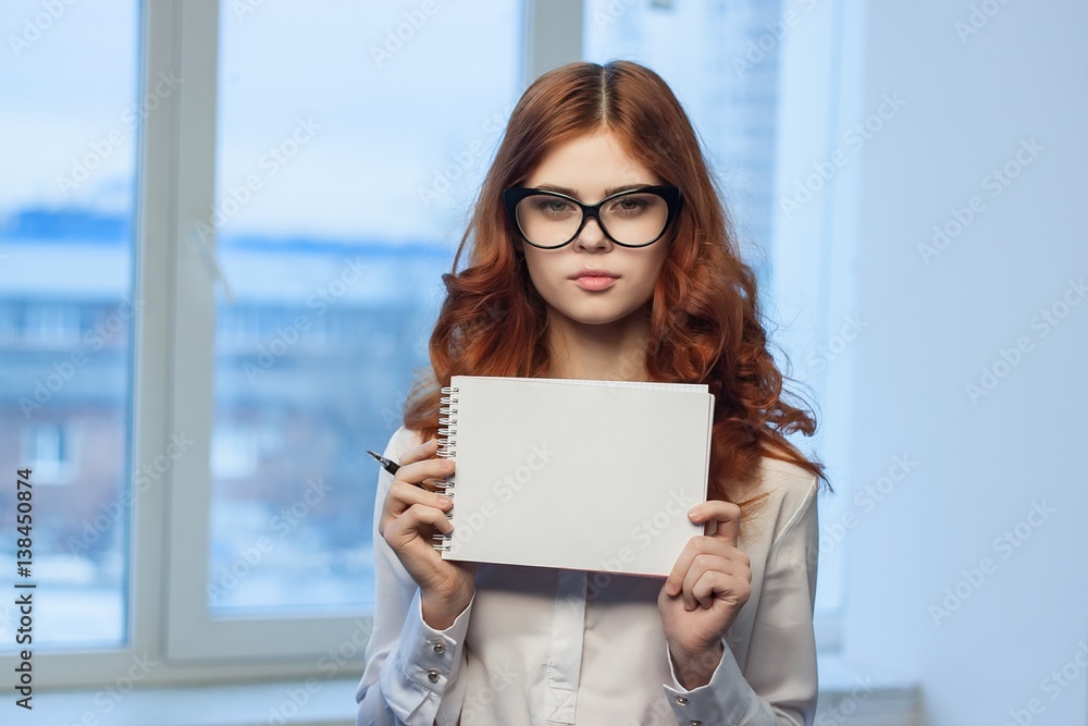 woman with glasses and a sheet of paper in hands