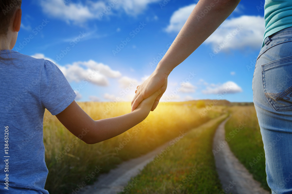 Hands of holding each other in field Hands of holding each other in field