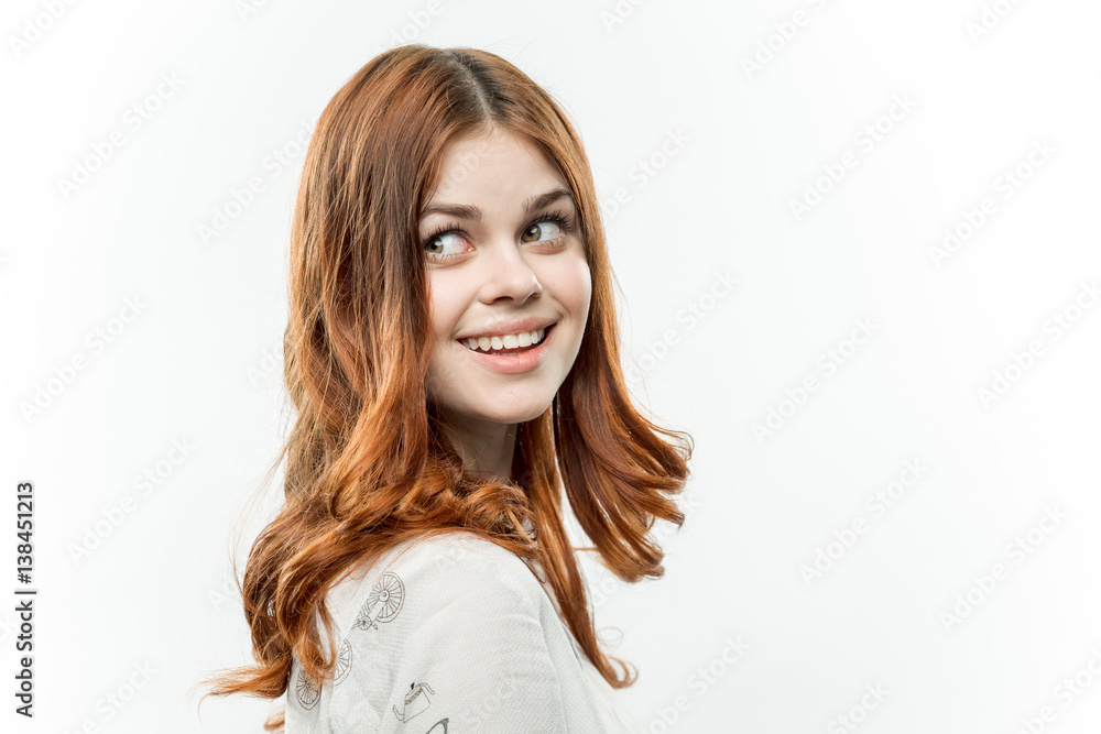 red-haired woman on a light background looked back to look back red-haired woman on a light background looked back to look back