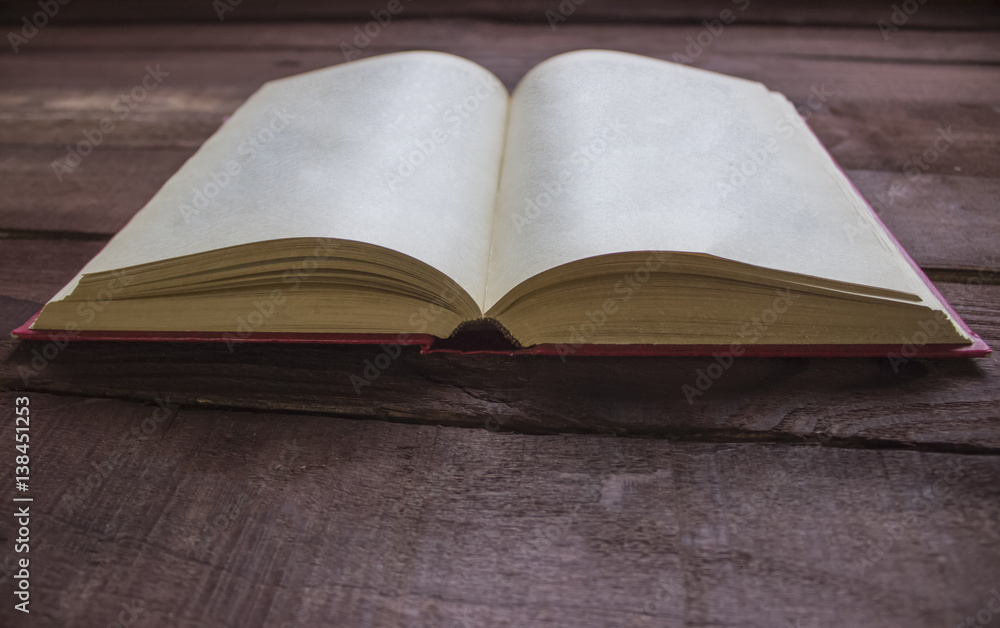Red book blank on wooden table Red book blank on wooden table