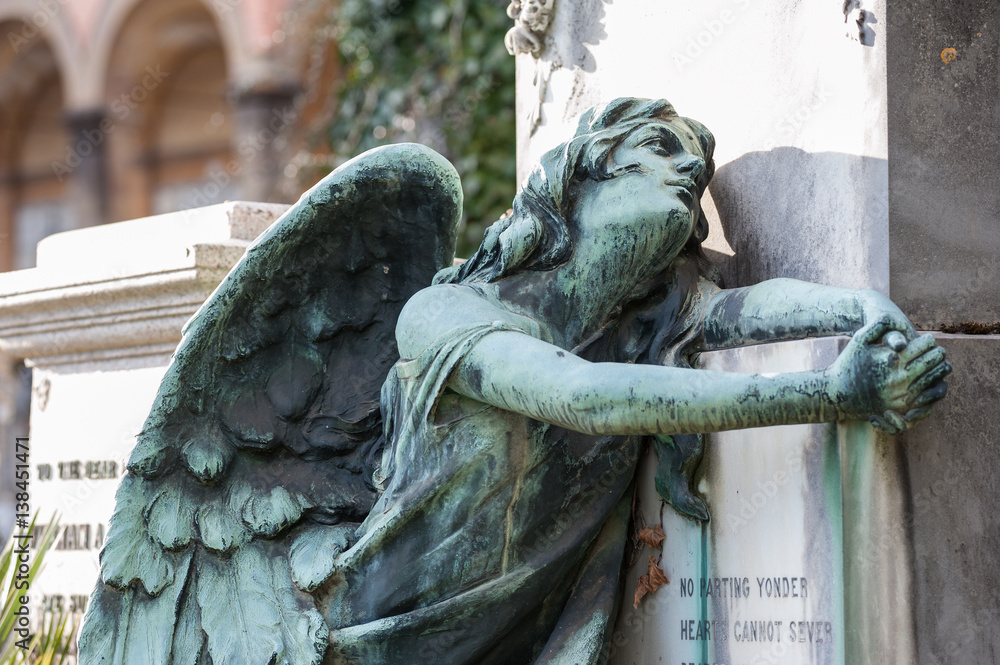 The afflicted angel kneeling on the tomb turns his gaze to the sky, praying to God