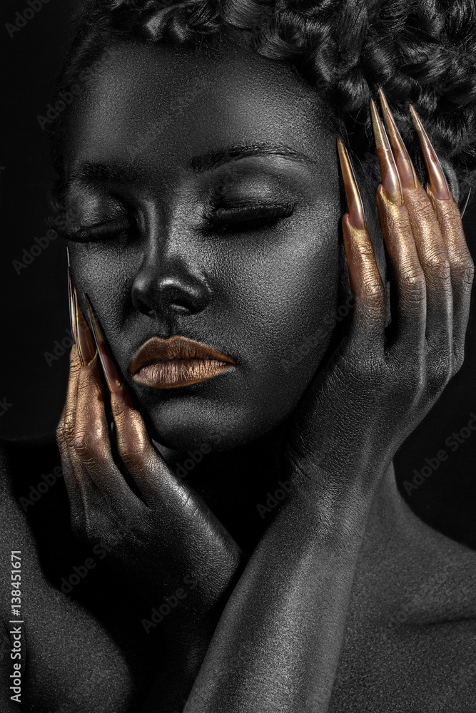 girl covered with black paint with gold lips and gold at your fingertips girl covered with black paint with gold lips and gold at your fingertips