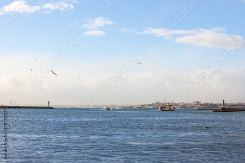 Ferry leaving the port of Kadikoy district, Asian side of the city of Istanbul, Turkey, heading to the European side, Ayasofya mosque can be seen in the background