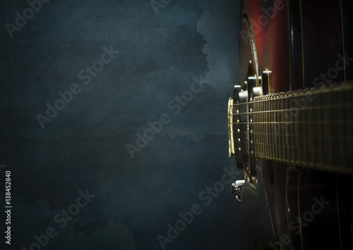 Canvas Print Close-up of old electric jazz guitar on a dark blue background