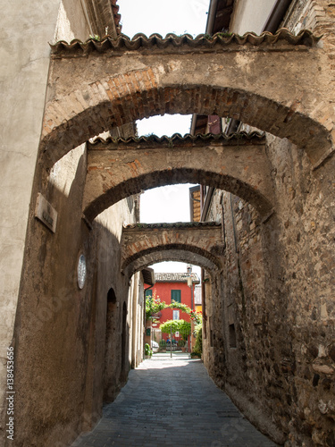  Picturesque narrow town street  in Sirmione  Lake Garda Italy.