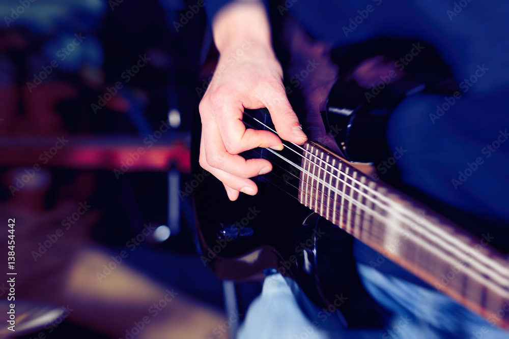 Naklejka premium Hand playing guitar, close up