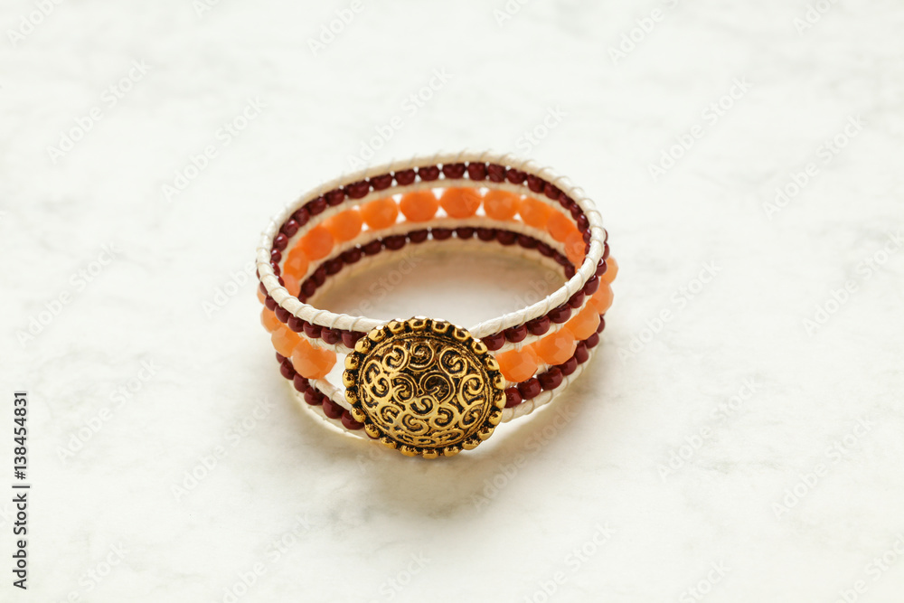 Handmade bracelet close up at marble stone pattern cardboard; no people, Handmade bracelet close up at marble stone pattern cardboard; no people,