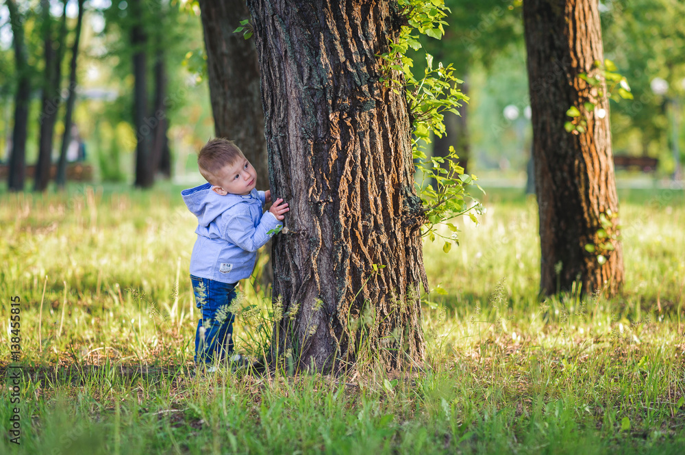 Little boy in fashionable clothing in the park.