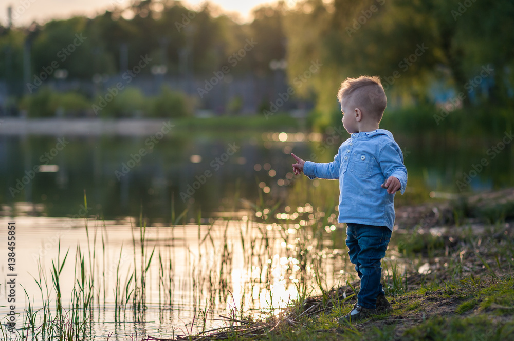 Little boy in fashionable clothing in the park.