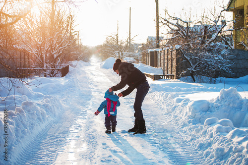 happy family with child walking in winter outdoors